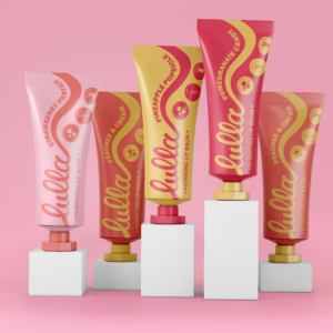 custom branding package- colorful lip balm tubes on white blocks against a pink background